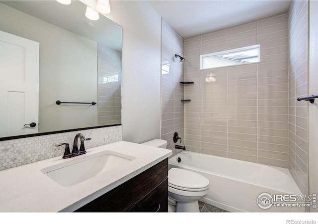 full bathroom with tiled shower / bath combo, vanity, and toilet