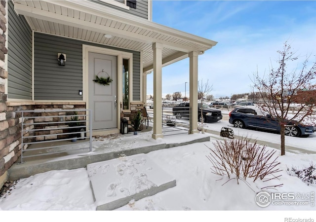 view of snow covered property entrance