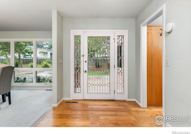 entryway with light colored carpet