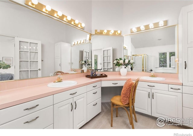 bathroom with lofted ceiling, vanity, and a shower with shower door