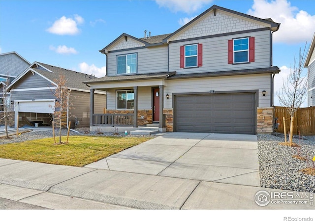 craftsman house with a porch, a garage, and a front yard