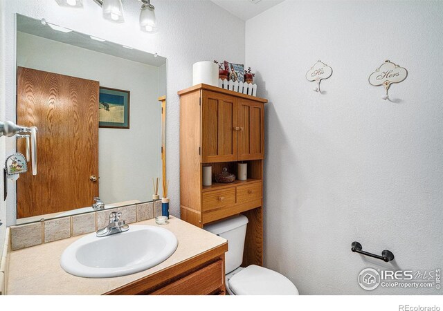 bathroom featuring vanity and toilet