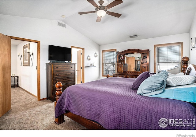 bedroom with ceiling fan, vaulted ceiling, and light carpet