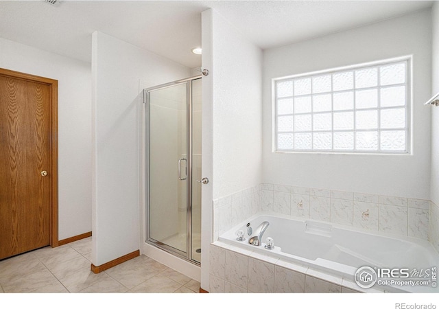 bathroom featuring tile patterned floors and separate shower and tub