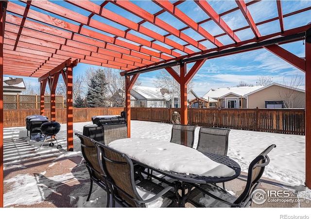 snow covered patio featuring a pergola