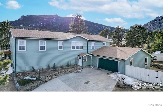 view of front of property with a garage and a mountain view