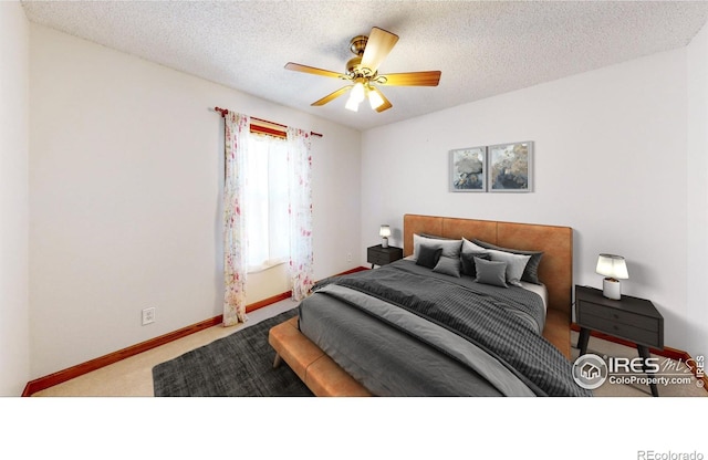 carpeted bedroom featuring a textured ceiling and ceiling fan