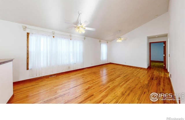 empty room featuring vaulted ceiling, ceiling fan, and light hardwood / wood-style floors