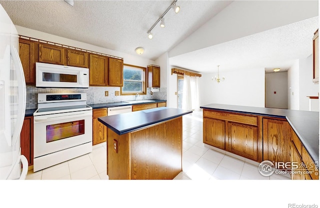 kitchen with vaulted ceiling, sink, decorative backsplash, a center island, and white appliances