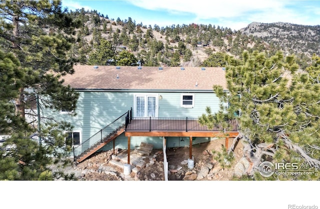 back of house with a deck with mountain view