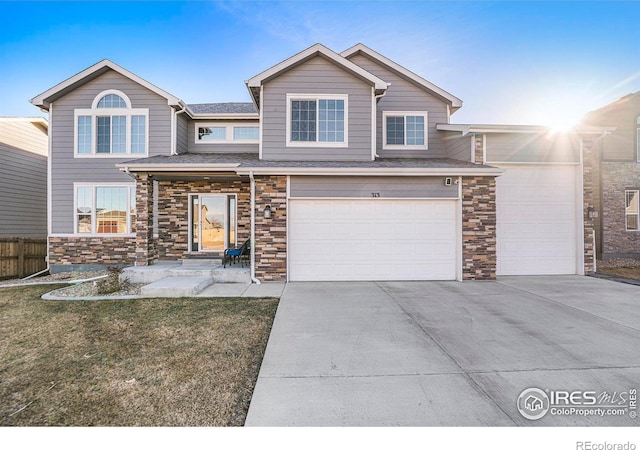 view of front of home featuring a garage and a front yard