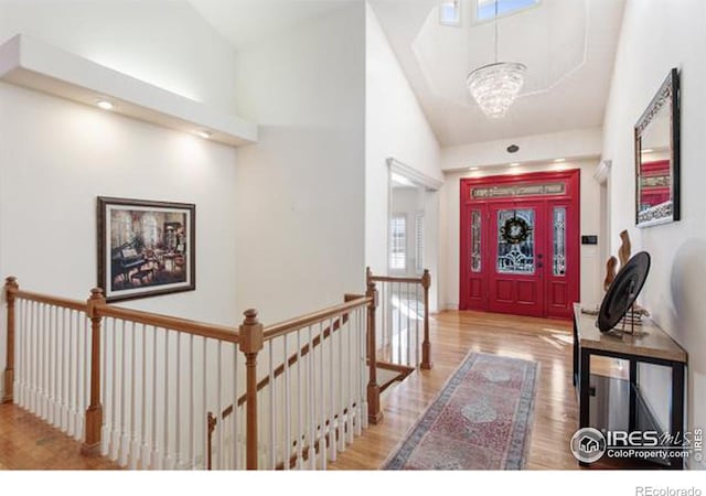 foyer with a notable chandelier and wood-type flooring