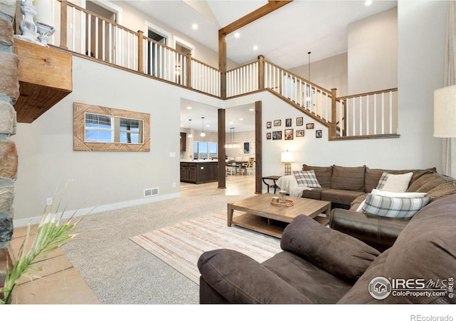 living room featuring a towering ceiling