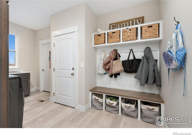 mudroom with light hardwood / wood-style floors