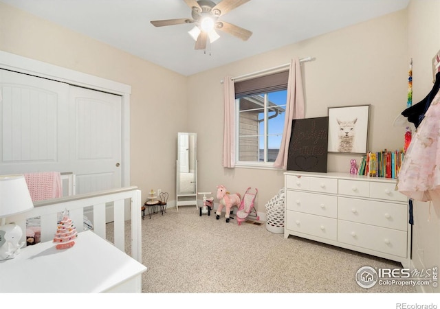 bedroom featuring ceiling fan, light colored carpet, and a closet