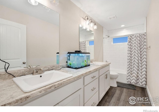 full bathroom with vanity, toilet, and shower / bath combo with shower curtain