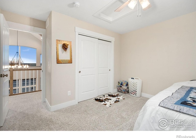 carpeted bedroom with ceiling fan and a closet