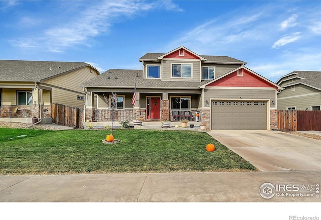 craftsman inspired home with a garage, a front yard, and covered porch