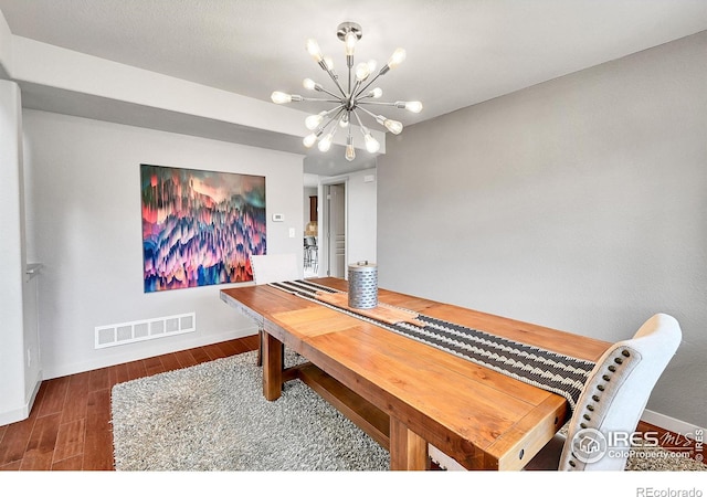 dining room featuring dark hardwood / wood-style floors and a chandelier