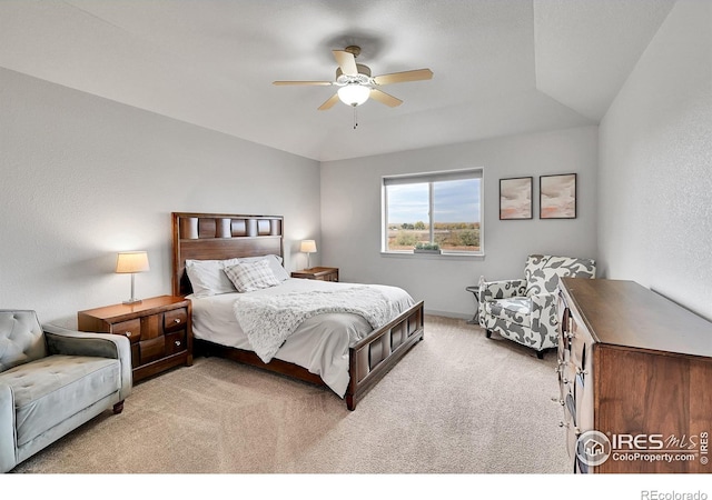 bedroom with vaulted ceiling, ceiling fan, and light colored carpet