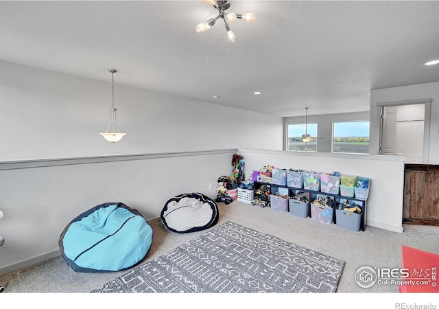 recreation room with ceiling fan and carpet flooring