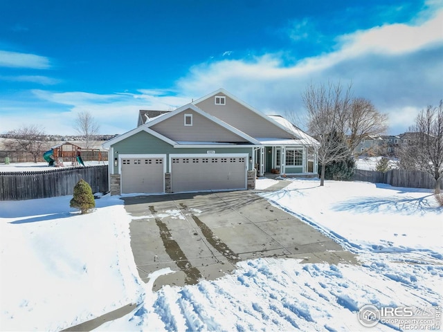 view of front of house featuring a garage and a playground