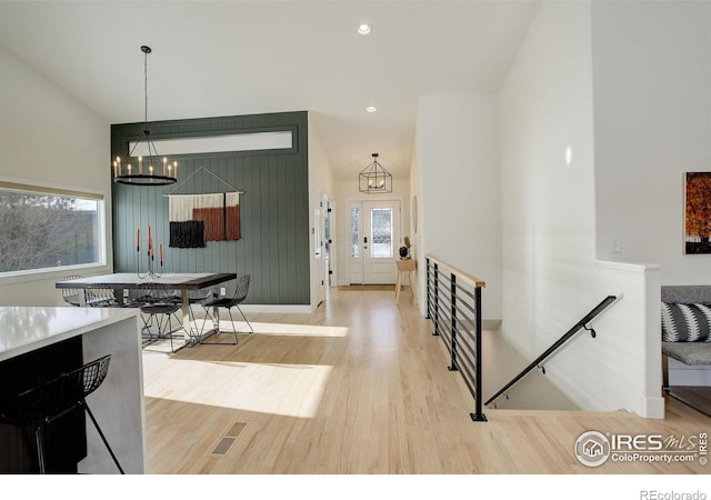 dining space featuring wood-type flooring and a chandelier