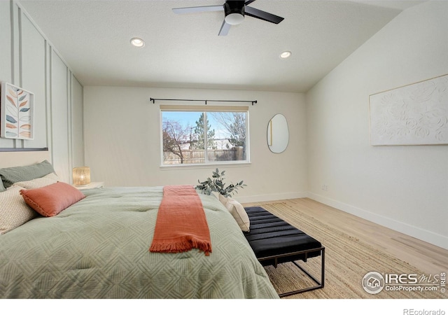 bedroom featuring ceiling fan, vaulted ceiling, and light wood-type flooring