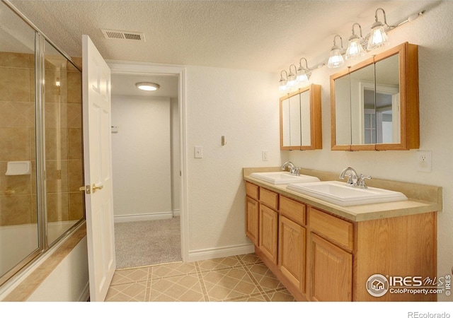 bathroom featuring vanity and a textured ceiling