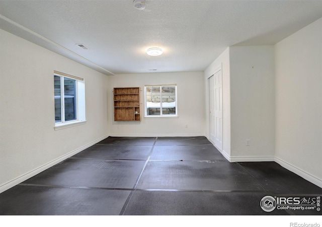 spare room featuring a textured ceiling