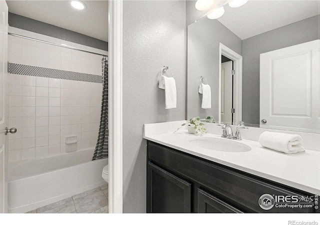 full bathroom featuring shower / tub combo, vanity, tile patterned floors, and toilet