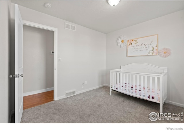 carpeted bedroom with a crib