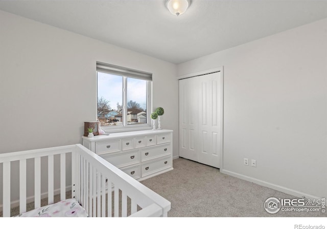 carpeted bedroom with a nursery area and a closet