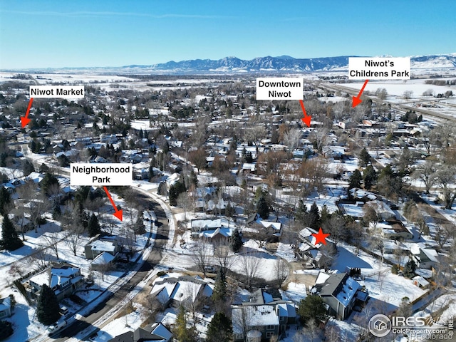 snowy aerial view featuring a mountain view