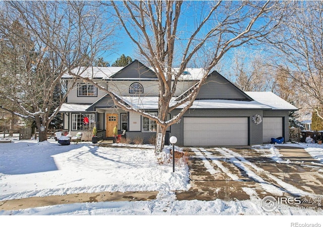 view of front of house with brick siding, driveway, and an attached garage