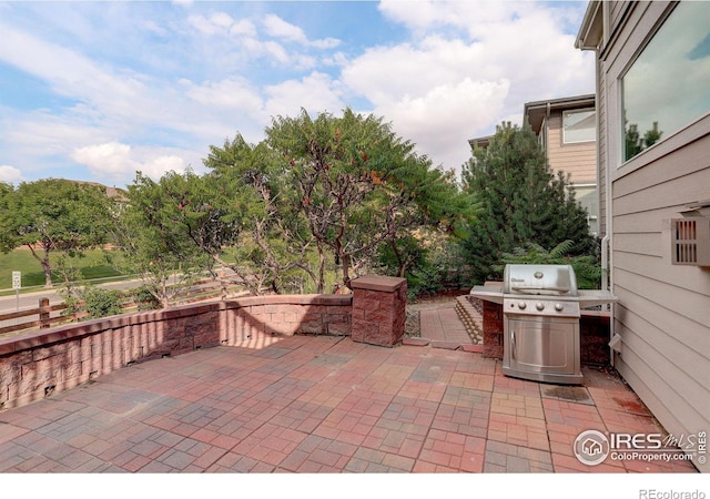 view of patio featuring a grill