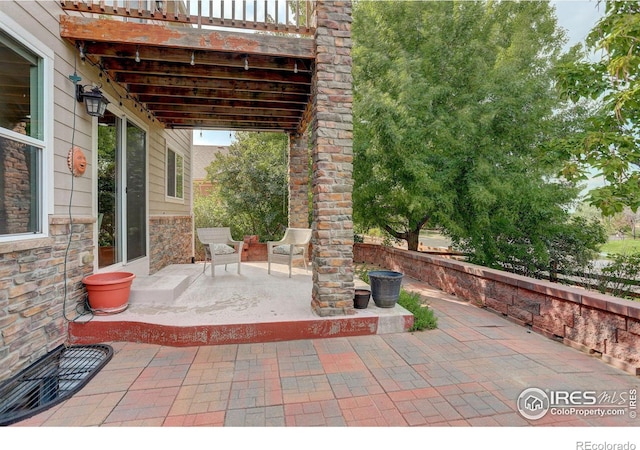 view of patio featuring a balcony