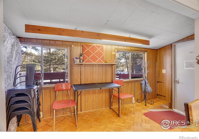 miscellaneous room featuring light parquet flooring and wood walls