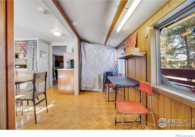 interior space featuring wooden walls and light parquet floors