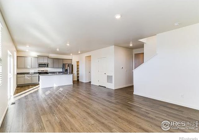 unfurnished living room featuring dark wood-type flooring