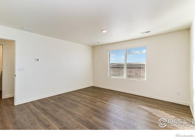 empty room with dark hardwood / wood-style floors