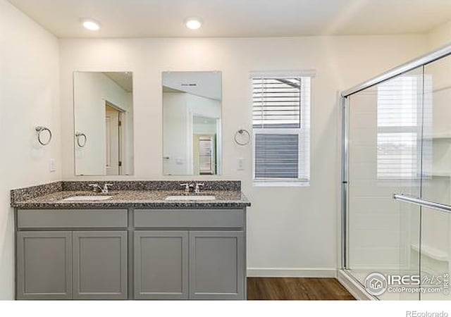 bathroom featuring an enclosed shower, hardwood / wood-style floors, and vanity