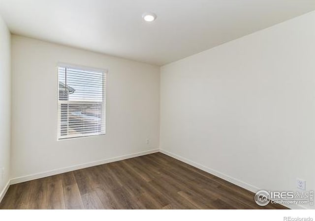 unfurnished room featuring dark hardwood / wood-style flooring