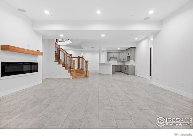 unfurnished living room with sink