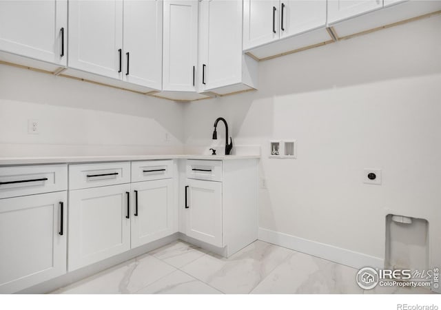 washroom with sink, hookup for a washing machine, cabinets, and hookup for an electric dryer