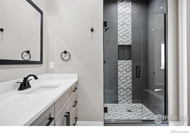 bathroom featuring walk in shower and vanity