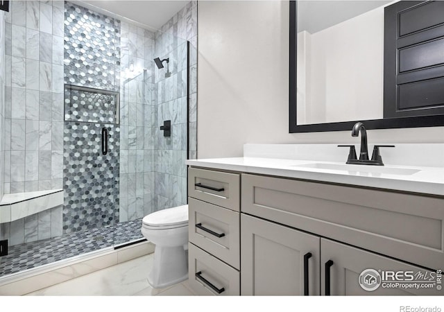 bathroom featuring vanity, toilet, and a shower with shower door