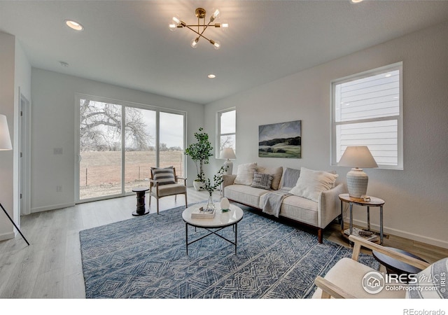 living room with hardwood / wood-style floors and a notable chandelier