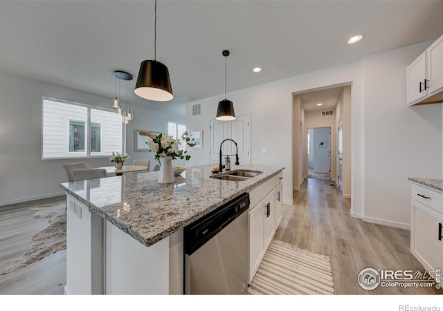 kitchen with sink, white cabinetry, dishwasher, pendant lighting, and a kitchen island with sink