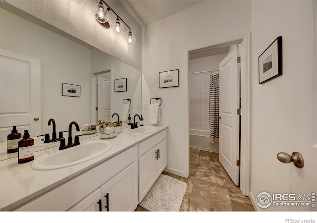 bathroom featuring shower / bath combo and vanity